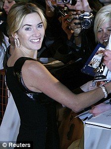 Kate Winslet poses with fans as she arrives for the European premiere of Revolutionary Roa